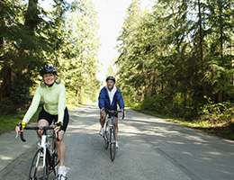  A man and woman riding bikes